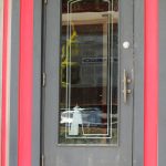 A lighthouse design on the front doors of the Cheers Bar and Grill building.