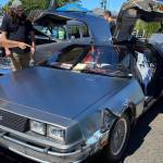 Attendees of the Saints Car Club Car Cruz in 2022 get an up-close look at a 1981 DeLorean.