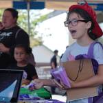 A young lady says thank you to a vendor at the Housing Kitsap Back to School event.