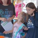 Elisha Meyer/Kitsap News Group Photos
Kyrie (8, left) and Riley (11, right) work their way through the tables outside of Housing Kitsap, where students were able to pick up supplies at a Back to School event last week.