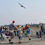 Crowds line up at the fence line to catch a glimpse at the underside of the PBY-5A-Catalina.