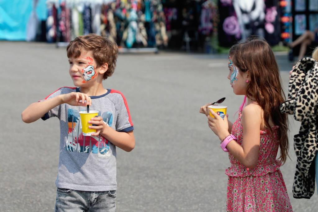 Two kids enjoy some frozen treats on a hot Sunday at the Kitsap Fair.