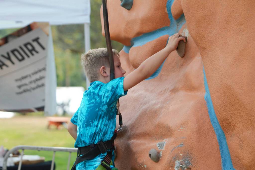 This boy comes up short of winning $100 at the top of the rock climb.