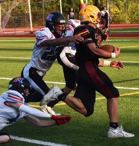 Nicholas Zeller-Singh/Kitsap News Group Photos
Camden Singer sheds the East Jefferson defenders for a touchdown.