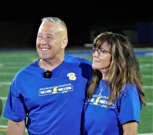 Elisha Meyer/Kitsap News Group Photos
Joe Kennedy puts his arm around his wife Denise while taking late-night questions on the field at Memorial Stadium.