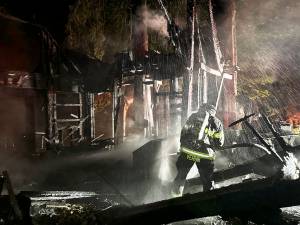 NKF&R courtesy photo
A firefighter fights the blaze between Kingston and Poulsbo early Sept. 4.