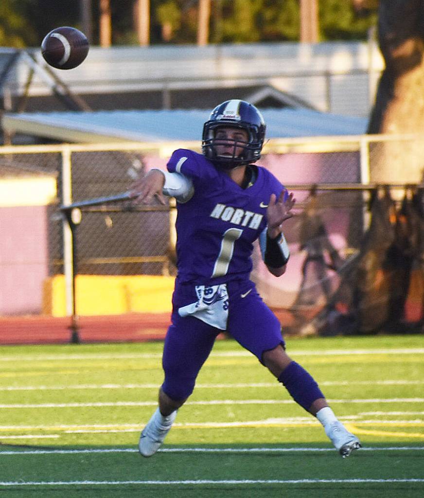 NKs Cole Edwards throws a touchdown after scrambling around the pocket.