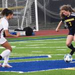 Spartan Gabby Weis challenges Buc Kate Collins for the ball.