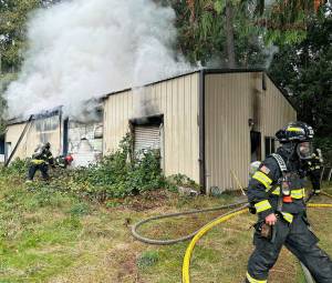 NKF&R courtesy photo
Firefighters work to access a fire Oct. 15 in a North Kitsap building that housed a home-based screen printing business.