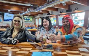 Elisha Meyer/Kitsap News Group
Jay Chan, Amanda Hughes and Bert Futch enjoy some drinks at the reopened Blue Goose Tavern.