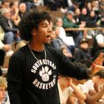Coach Anthony Lewis guides his team from the bench.