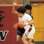 Junior Josaiah Asuega drives into the paint midway through the first quarter.