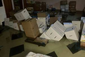 South Kitsap Helpline courtesy photo
Standing water in the basement of the South Kitsap Helpline property consumes and topples several boxes containing dry food storage.
