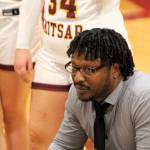 Coach Dexter Clark speaks with his players during a timeout in the fourth quarter.