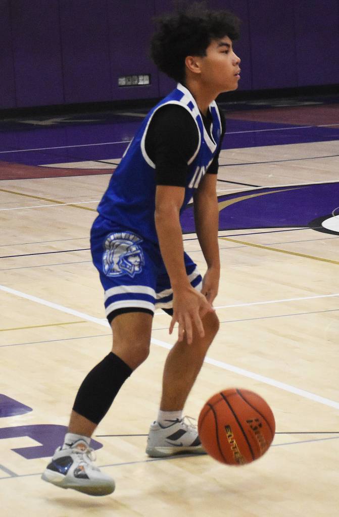 Olympics Isaiah Baleto dribbles the ball down the court.