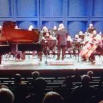 The symphony on stage, featuring Alec Rodriguez, left.