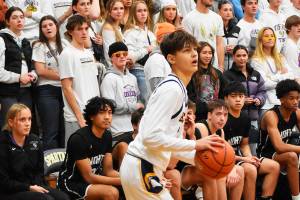 Nicholas Zeller-Singh/Kitsap News Group Photos
Spartan Kaden Thielman scores a three-point shot from the corner.