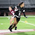 A Bethel ball carrier runs for an opening with Wolves defenders in pursuit.