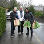 Volunteers help load the bags and deliver them across the island.