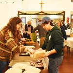 Nicholas Zeller-Singh/Kitsap News Group Photos
Volunteers set up an assembly line to serve food for Bainbridge Islanders.