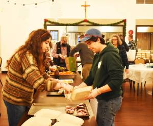 Nicholas Zeller-Singh/Kitsap News Group Photos
Volunteers set up an assembly line to serve food for Bainbridge Islanders.