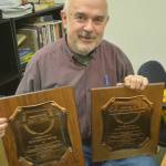 Steve Powell/Kitsap News Group Photos
Charlie Averill shows WNPA president plaques received by both his dad and mom while they were with the Bainbridge Island Review.