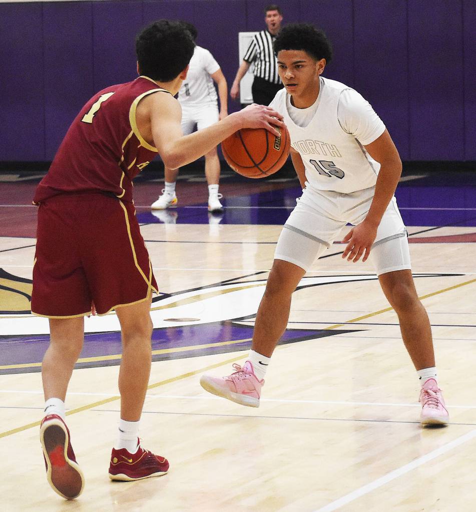 Buc Rhys Hernandez sizes up Viking Jordan Williams while playing defense.