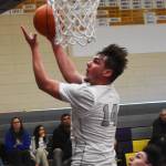 Logan Hudson goes for a layup for NK.