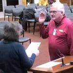 Doug Newell is sworn into council by Mayor Becky Erickson.