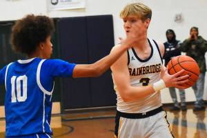 Nicholas Zeller-Singh/Kitsap News Group Photos
Spartan Sam Nylund battles Knight Jalen Davis until the final buzzer.