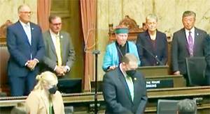 Steve Powell/Kitsap News Group
Rev. Dee Eisenhower of Bainbridge Island gives the opening prayer at Gov. Jay Inslees State of the State address.