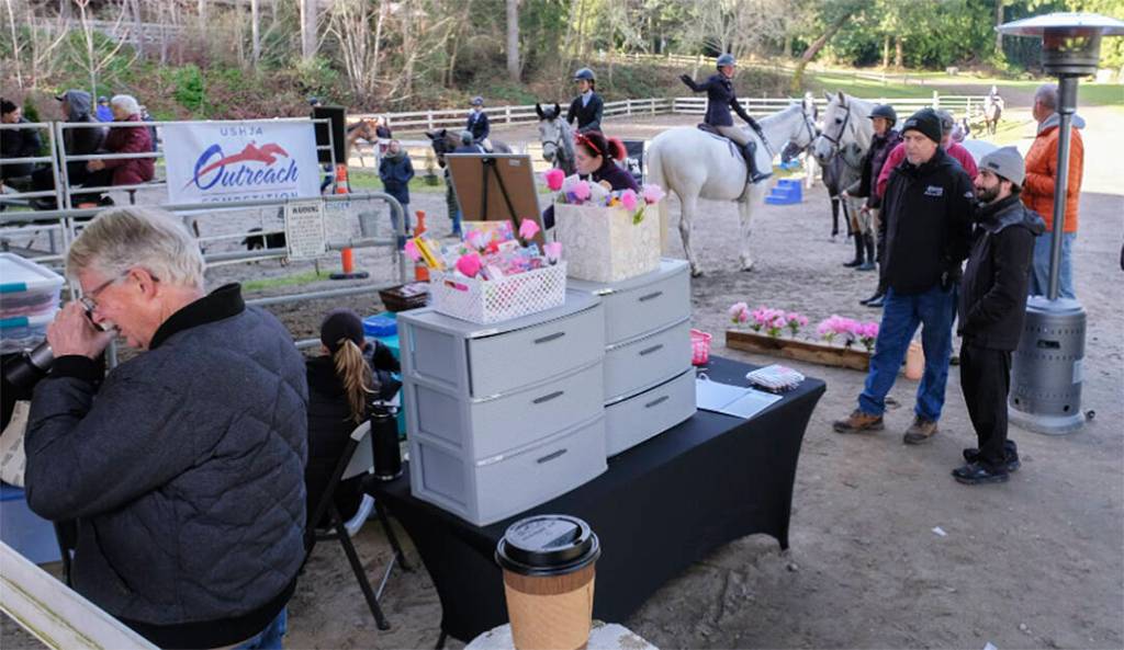 Participants and onlookers gather around the venue.