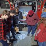 Elisha Meyer/Kitsap News Group photos
The Mercy Mobile volunteers huddle together with a couple homeless people for a moment of prayer.