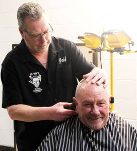 Elisha Meyer/Kitsap News Group
Jeff Crenshaw steadies the head of a customer while putting the finishing touches on a haircut.