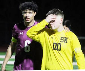 Elisha Meyer/Kitsap News Group photos
Senior Brandon Durr, left, walks off the field with his hand around the shoulder of senior goalie Landon Kirby seconds after Olympias victory over the South Kitsap Wolves.