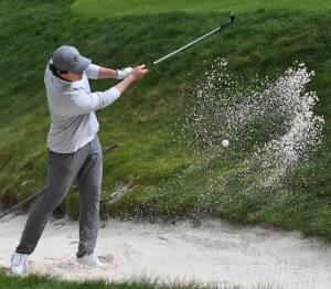 Nicholas Zeller-Singh/Kitsap News Group photos
Spartan Andrew Jobes hits a bunker shot onto the green.