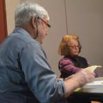 Historic Preservation Commission member Eric Kortum reads his resignation letter, as Susan Hughes shows her displeasure with the proceedings.