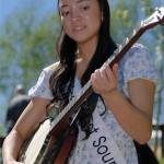 Miss West Sound Allari Strong plays a banjo.