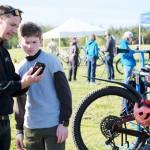 Damon Williams/Kitsap News Group photos
Buck Giles shows a team member an app about the race on his phone.