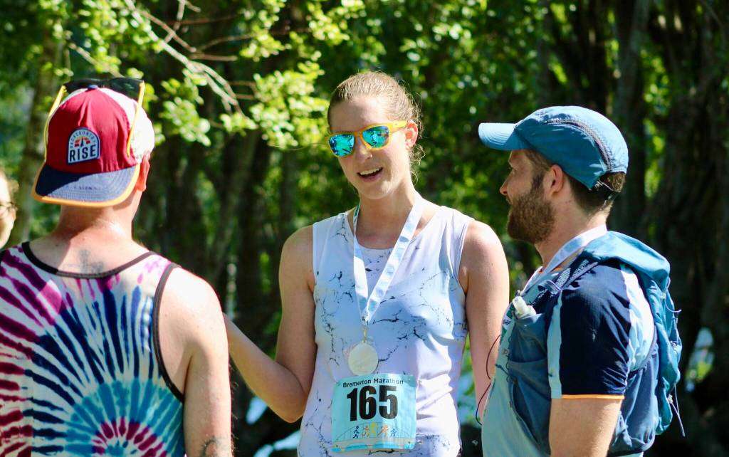 Megan Morris shares congratulations with fellow racers after completing her half marathon first among the female racers.