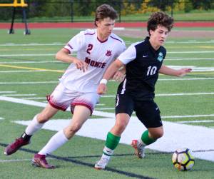 Eagle sophomore Myles Peterson battles for the ball against Montesano.