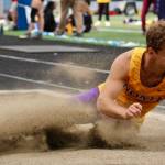 North Kitsaps Logan Sloman lands in the sand during long jump.
