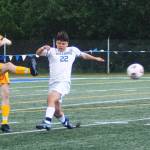 Spartan senior defender Finn McCallum (22) kicks the ball upfield against the Bulldogs.