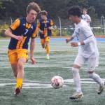 Freshman forward Howard Howlett IV (7) goes for a steal against MV.