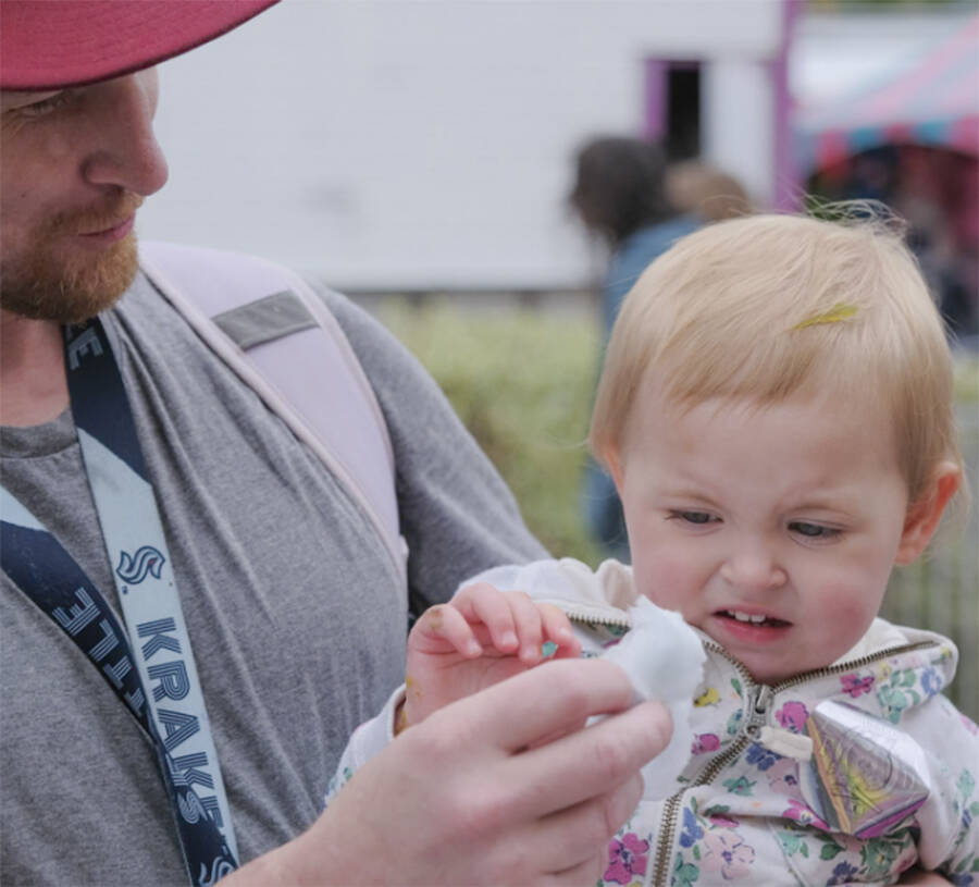 Camille Seelye looks a little uneasy about eating this sticky cotton candy stuff, despite assurances from her dad Chaz.