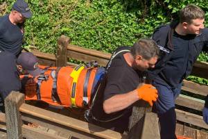 PDF courtesy photo
First responders bring the woman up a flight of stairs after she fell over 20 feet and suffered a head injury.