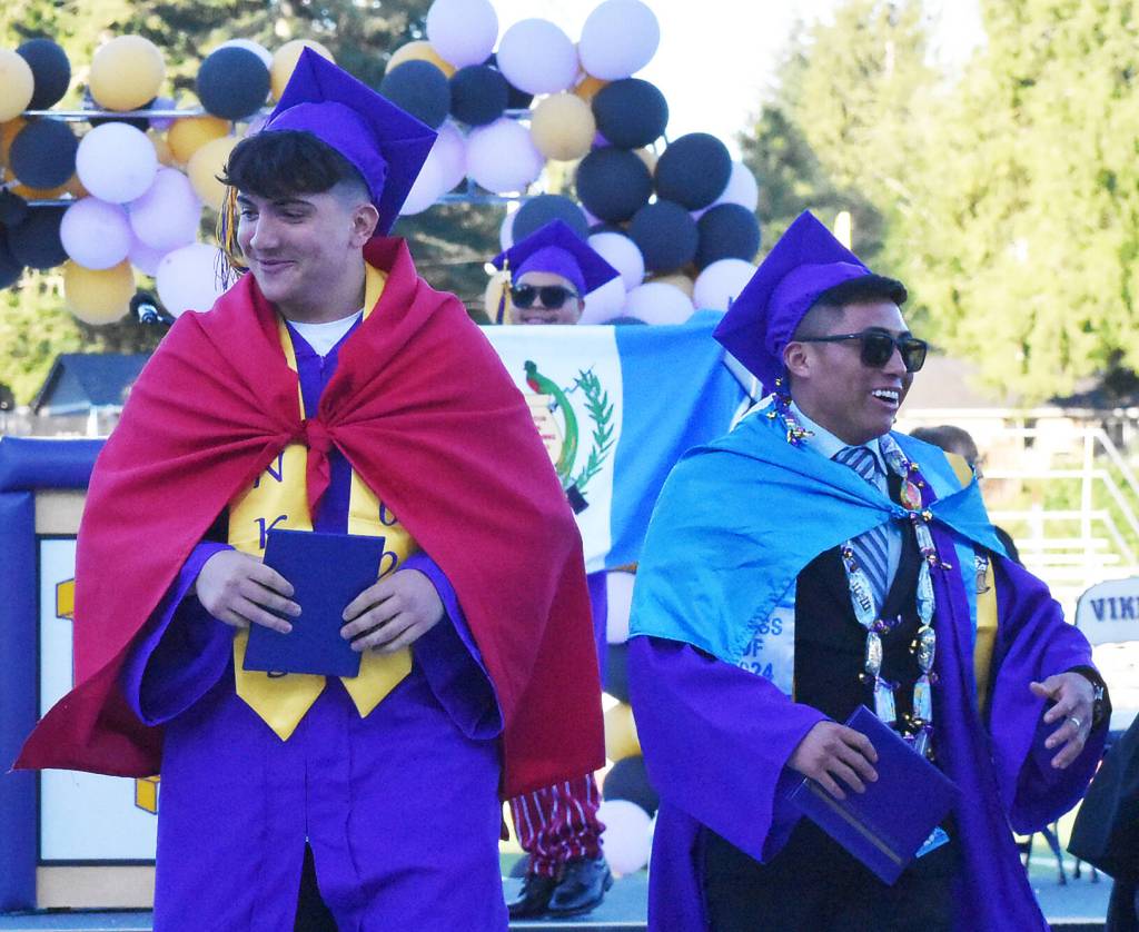 NK graduates celebrate with their national flags.