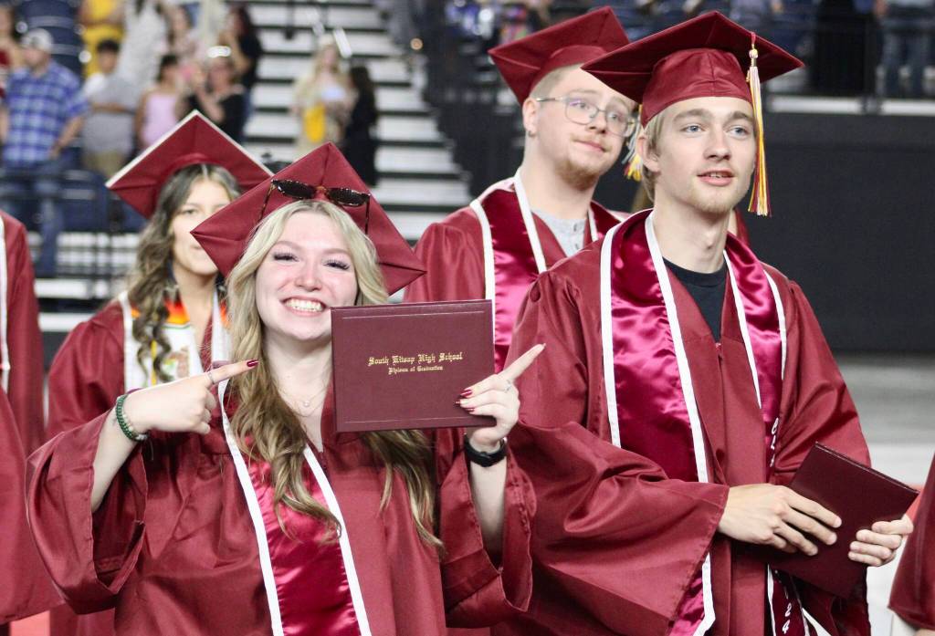 The graduates are proud to show off their newly acquired high school diplomas.