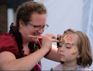 Damon Williams/Kitsap News Group photos
Frida Haas makes Kimberly Wisner a work of art at the Kingston Pirate Festival June 8.