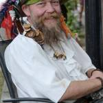 Mantis Quinn shows his commitment to piracy showing off wooden tokens that dangle from his hat.